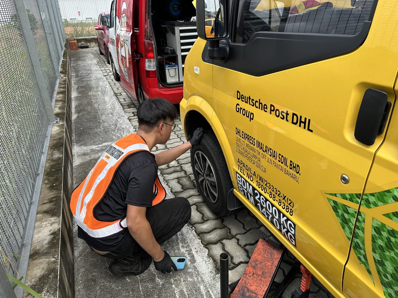 CarShifu technician inspecting the wheel of a fleet delivery van during scheduled preventive maintenance in KL