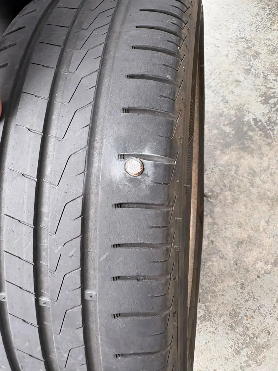 Screw stuck in a car tyre tread